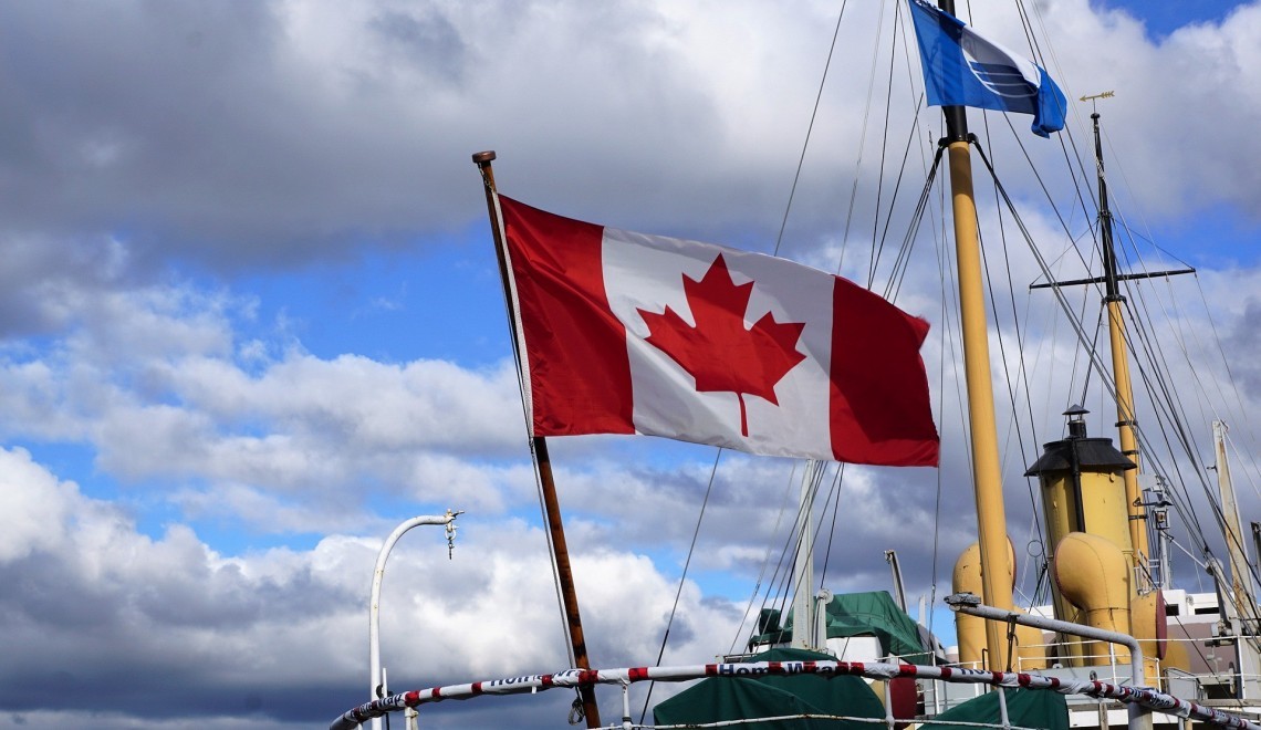 Save on travel this fall. Canadian flag flies in Halifax.