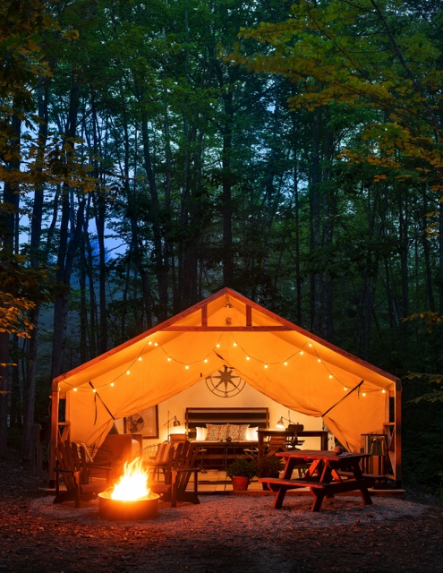 orange-tinted tent lit up by cozy fireplace
